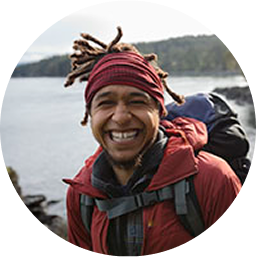a man smiling with a backpack